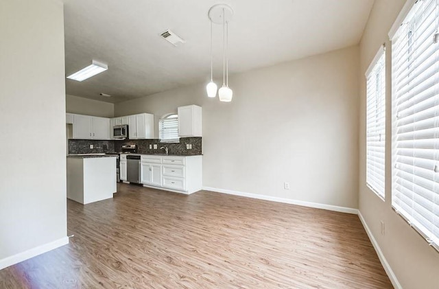4611 Green Trail Dr, Houston, TX 77084 - kitchen with stainless steel appliances, wood finished floors, healthy amount of natural light, and backsplash