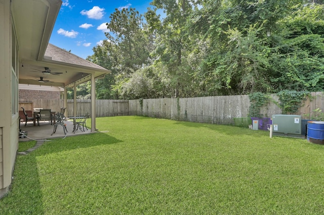 7455 Durango Creek Dr, Magnolia, TX 77354 - fenced backyard with ceiling fan and a patio