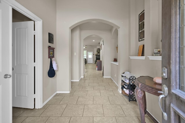 7455 Durango Creek Dr, Magnolia, TX 77354 - hallway with light tile patterned flooring and arched walkways