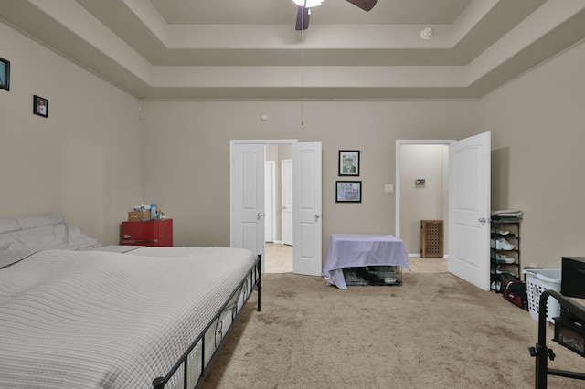 7455 Durango Creek Dr, Magnolia, TX 77354 - carpeted bedroom with a tray ceiling, a ceiling fan, and a towering ceiling