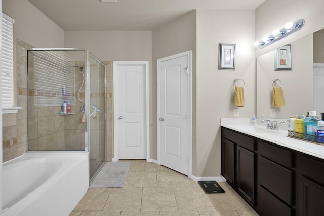 7455 Durango Creek Dr, Magnolia, TX 77354 - bathroom with vanity, a shower stall, a garden tub, and tile patterned floors
