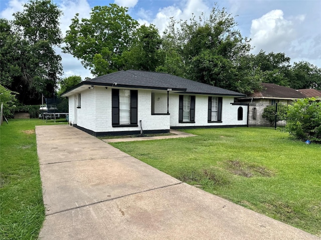 6618 Hopper Rd, Houston, TX 77016 - ranch-style home featuring a trampoline, concrete driveway, brick siding, and roof with shingles