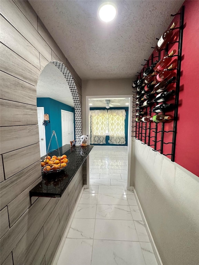 6618 Hopper Rd, Houston, TX 77016 - hall with a textured ceiling, marble finish floors, and arched walkways