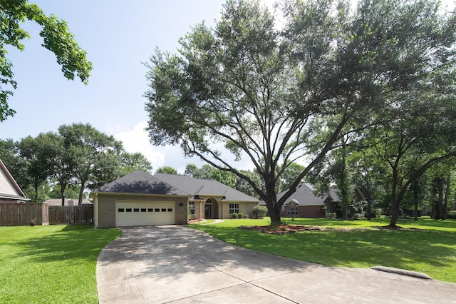 2452 Ripplewood Dr, Conroe, TX 77384 - ranch-style house featuring a garage and concrete driveway