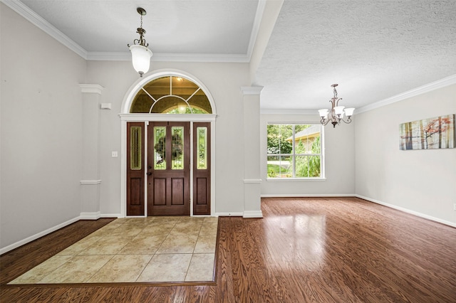 2452 Ripplewood Dr, Conroe, TX 77384 - foyer with a chandelier, wood finished floors, and crown molding