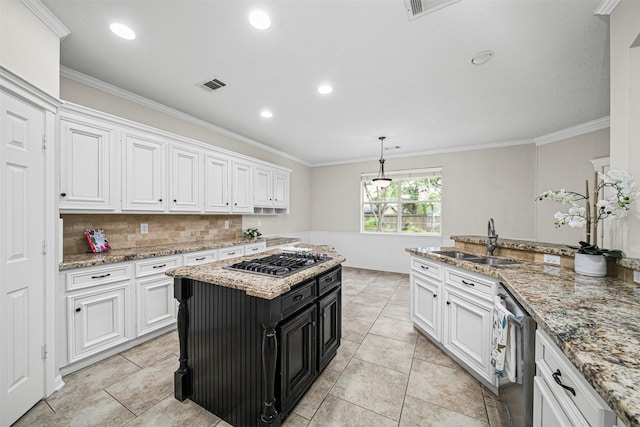 2452 Ripplewood Dr, Conroe, TX 77384 - kitchen with stainless steel appliances, white cabinetry, dark cabinets, decorative backsplash, and ornamental molding