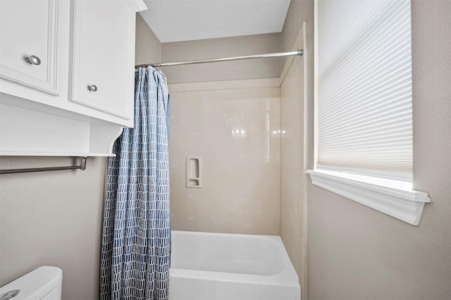 2452 Ripplewood Dr, Conroe, TX 77384 - bathroom featuring shower / bathtub combination with curtain and toilet