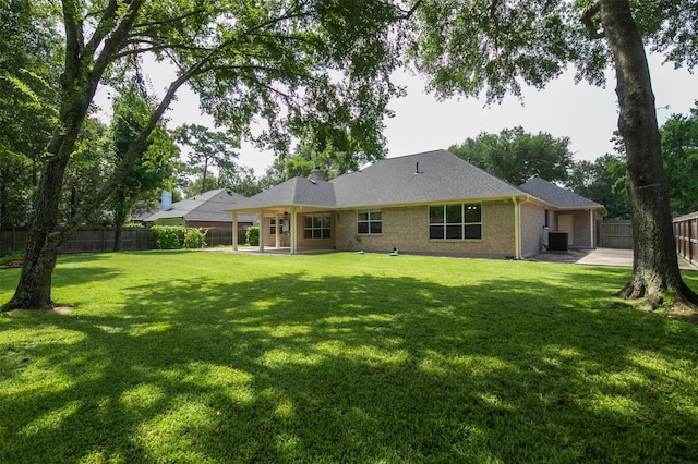 2452 Ripplewood Dr, Conroe, TX 77384 - rear view of house featuring a fenced backyard, a patio area, and brick siding