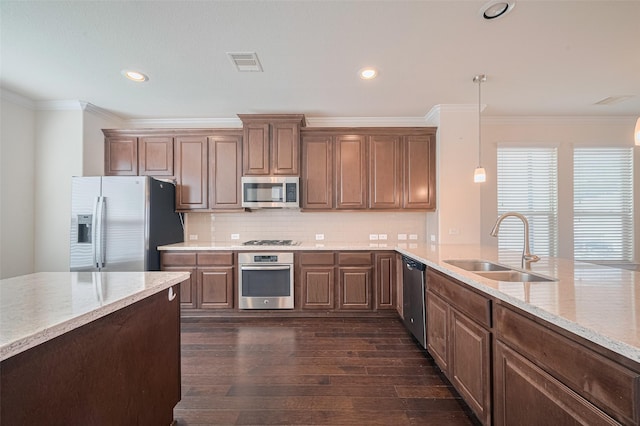 10004 Spring Shadows Park Cir, Houston, TX 77080 - kitchen featuring stainless steel appliances, dark wood finished floors, ornamental molding, backsplash, and light stone counters