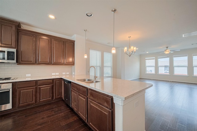 10004 Spring Shadows Park Cir, Houston, TX 77080 - kitchen featuring stainless steel appliances, a peninsula, dark wood-style floors, a ceiling fan, and backsplash
