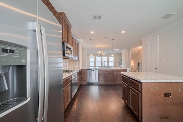 10004 Spring Shadows Park Cir, Houston, TX 77080 - kitchen featuring stainless steel appliances, a peninsula, dark wood-style floors, a chandelier, and recessed lighting