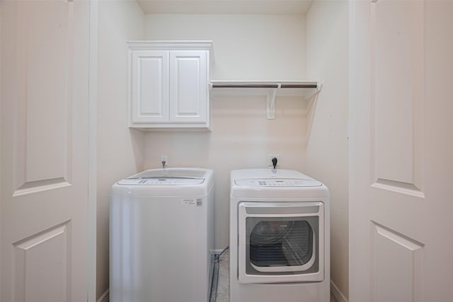 10004 Spring Shadows Park Cir, Houston, TX 77080 - laundry room with cabinet space and independent washer and dryer