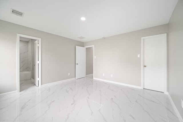 18935 Remington Bend Dr, Houston, TX 77073 - unfurnished bedroom with light marble finish floors, recessed lighting, and ensuite bathroom