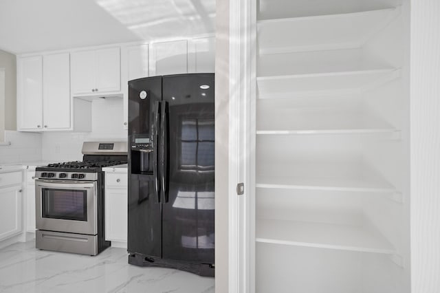 18935 Remington Bend Dr, Houston, TX 77073 - kitchen with black refrigerator with ice dispenser, gas stove, white cabinetry, light marble finish floors, and backsplash