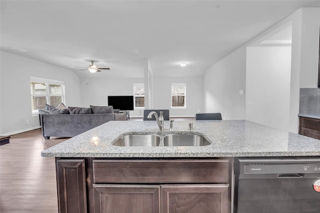 12326 Sabine Point Dr, Humble, TX 77346 - kitchen featuring stainless steel dishwasher, dark brown cabinetry, a ceiling fan, light stone counters, and wood finished floors