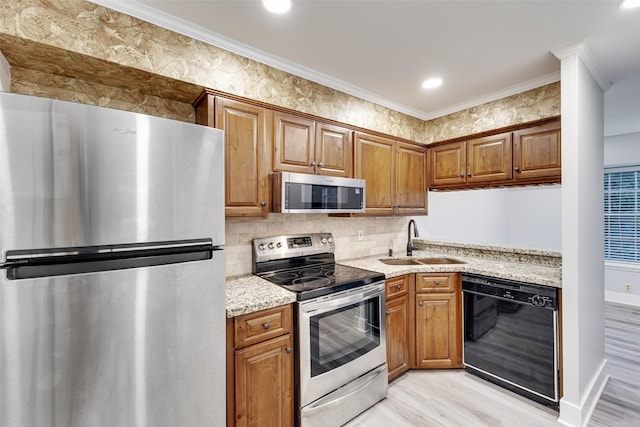2501 Marilee Ln Unit 4, Houston, TX 77057 - kitchen featuring appliances with stainless steel finishes, ornamental molding, light wood-style flooring, brown cabinetry, and decorative backsplash