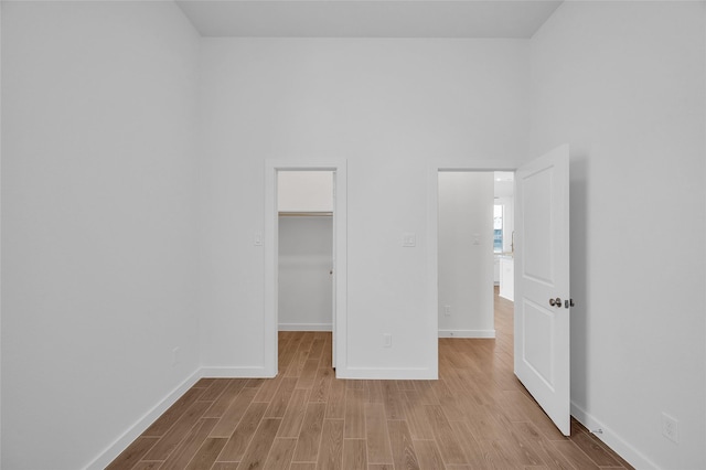 30218 Indigo Falls Dr, Brookshire, TX 77423 - unfurnished bedroom featuring wood finished floors, a spacious closet, and a closet