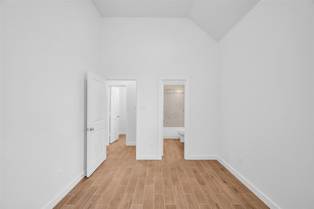 30218 Indigo Falls Dr, Brookshire, TX 77423 - unfurnished bedroom with light wood-type flooring, high vaulted ceiling, and ensuite bath