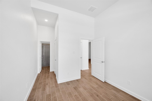 30218 Indigo Falls Dr, Brookshire, TX 77423 - unfurnished bedroom featuring light wood-style floors, recessed lighting, and a spacious closet