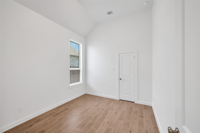 30218 Indigo Falls Dr, Brookshire, TX 77423 - empty room featuring light wood-style flooring, vaulted ceiling, and a smoke detector