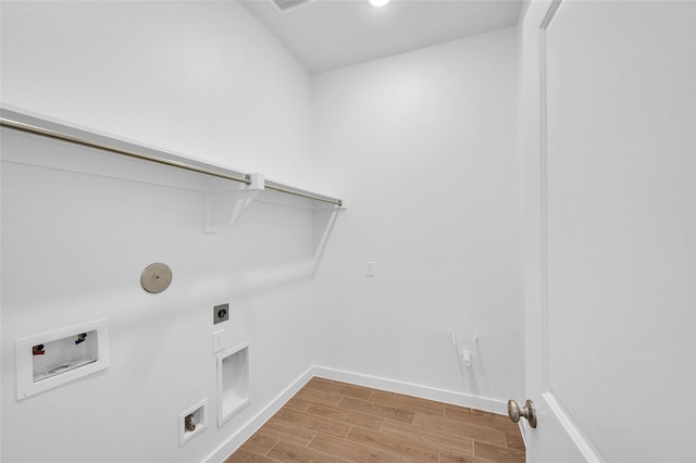 30218 Indigo Falls Dr, Brookshire, TX 77423 - laundry area with washer hookup, light wood-style floors, electric dryer hookup, and hookup for a gas dryer