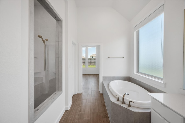 30218 Indigo Falls Dr, Brookshire, TX 77423 - bathroom featuring a bath, healthy amount of natural light, tiled shower, lofted ceiling, and vanity
