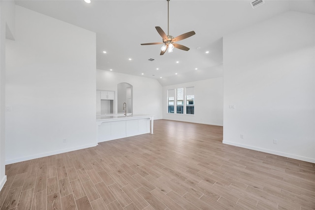 30218 Indigo Falls Dr, Brookshire, TX 77423 - unfurnished living room with lofted ceiling, a ceiling fan, light wood-style flooring, arched walkways, and recessed lighting