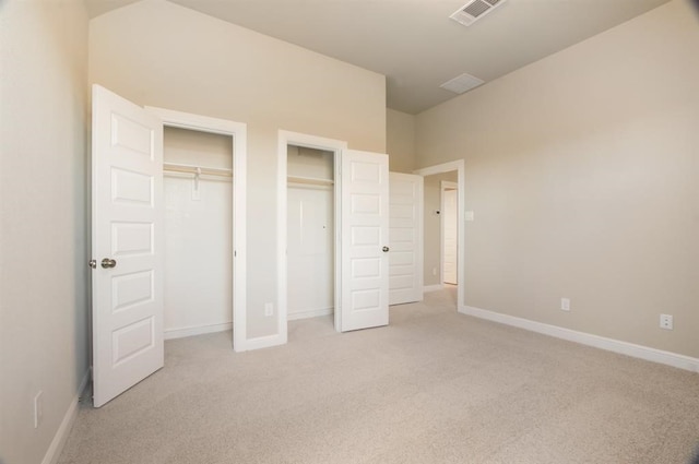 5715 Caper Shores Ln, Sugar Land, TX 77479 - unfurnished bedroom featuring light colored carpet and two closets