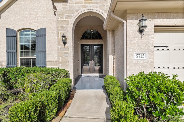 5715 Caper Shores Ln, Sugar Land, TX 77479 - doorway to property with french doors, stone siding, and brick siding