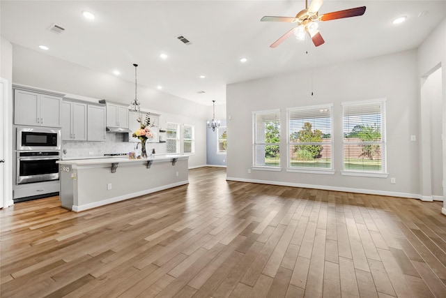 5715 Caper Shores Ln, Sugar Land, TX 77479 - kitchen with oven, black microwave, open floor plan, light countertops, and ceiling fan