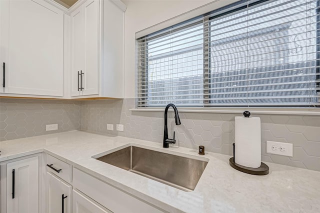 3226 Longleaf Meadows Dr, Houston, TX 77063 - kitchen featuring white cabinetry, light stone countertops, and decorative backsplash