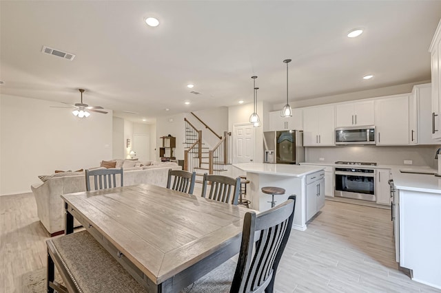 3226 Longleaf Meadows Dr, Houston, TX 77063 - dining area with recessed lighting, ceiling fan, light wood finished floors, and stairway