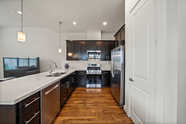 3929 Tulane Oak Dr, Houston, TX 77018 - kitchen featuring appliances with stainless steel finishes, dark wood finished floors, backsplash, a peninsula, and pendant lighting