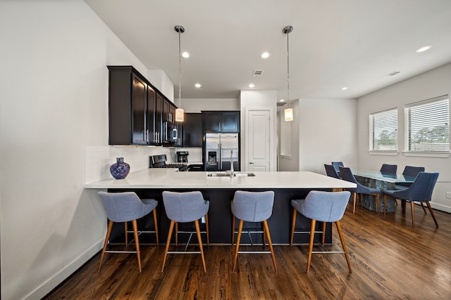 3929 Tulane Oak Dr, Houston, TX 77018 - kitchen featuring stainless steel appliances, dark wood-style flooring, light countertops, backsplash, and recessed lighting