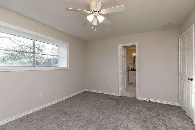12707 Pleasant Grove Rd, Cypress, TX 77429 - unfurnished bedroom with carpet floors, connected bathroom, and a ceiling fan