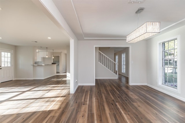 12707 Pleasant Grove Rd, Cypress, TX 77429 - unfurnished living room with dark wood-style flooring, stairs, recessed lighting, and a chandelier