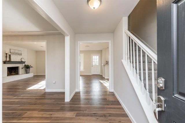 12707 Pleasant Grove Rd, Cypress, TX 77429 - foyer entrance with dark wood finished floors, stairway, and a brick fireplace