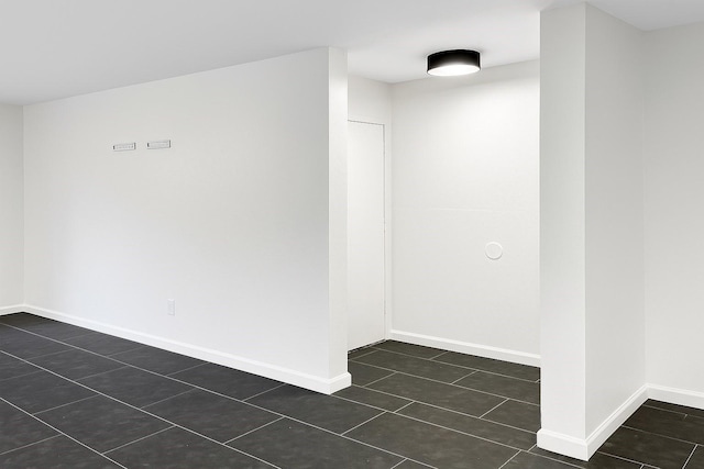 12905 Woodforest Blvd Unit 709, Houston, TX 77015 - unfurnished room with dark tile patterned flooring and baseboards