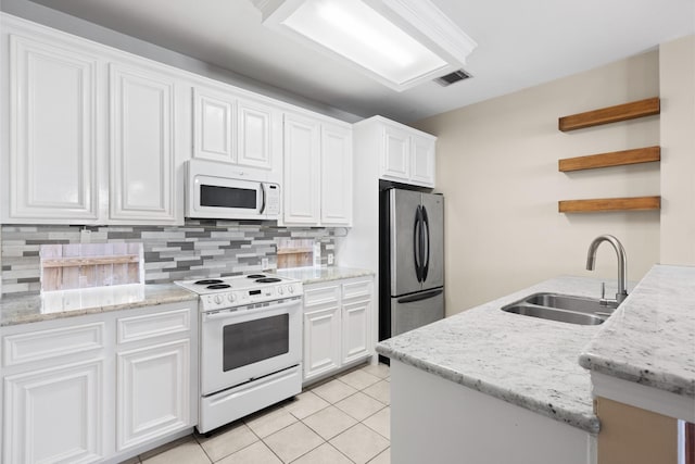 1708 Dennis St, Houston, TX 77004 - kitchen featuring white appliances, open shelves, white cabinets, backsplash, and light tile patterned floors