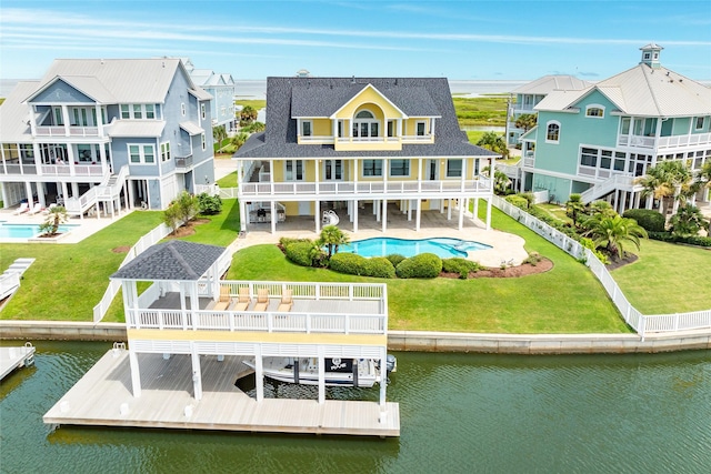 20611 E Sunset Bay Dr, Galveston, TX 77554 - rear view of house with a balcony, a water view, an outdoor pool, a patio area, and boat lift