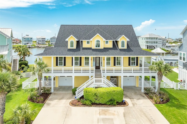 20611 E Sunset Bay Dr, Galveston, TX 77554 - view of front of property with driveway, an attached garage, and a porch