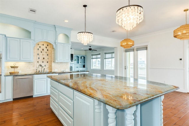 20611 E Sunset Bay Dr, Galveston, TX 77554 - kitchen with dishwasher, a chandelier, dark wood-style floors, ornamental molding, and backsplash