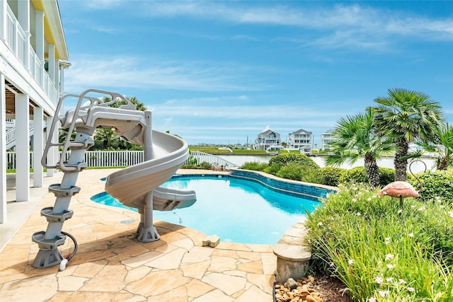 20611 E Sunset Bay Dr, Galveston, TX 77554 - outdoor pool with a water slide, a water view, and a patio area