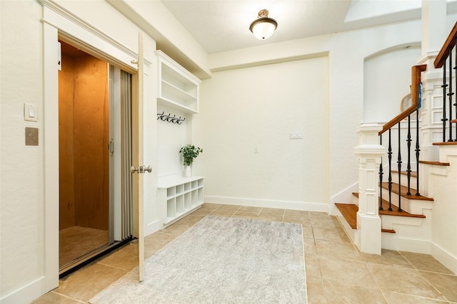 20611 E Sunset Bay Dr, Galveston, TX 77554 - mudroom featuring light tile patterned flooring and baseboards