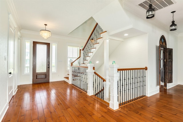20611 E Sunset Bay Dr, Galveston, TX 77554 - foyer featuring hardwood / wood-style flooring, ornamental molding, a chandelier, and stairs