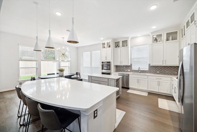 1120 Wakefield Dr, Houston, TX 77018 - kitchen with stainless steel appliances, a center island, dark wood finished floors, healthy amount of natural light, and recessed lighting