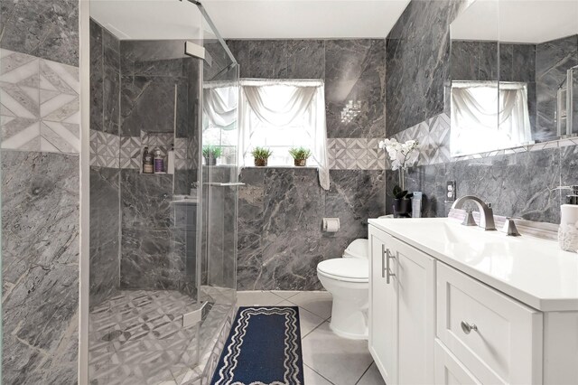 1318 Des Jardines St, Houston, TX 77023 - bathroom featuring tile walls, a shower stall, vanity, plenty of natural light, and tile patterned floors