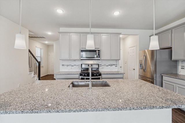 10967 Cannes Memorial Dr, Houston, TX 77043 - kitchen featuring stainless steel appliances, gray cabinets, light stone countertops, backsplash, and recessed lighting