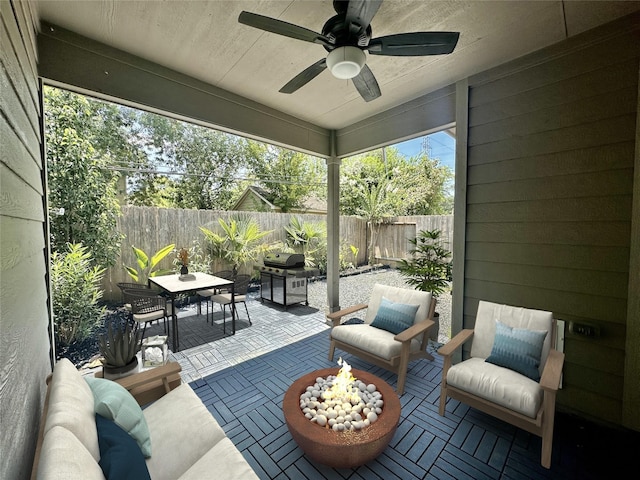 10967 Cannes Memorial Dr, Houston, TX 77043 - fenced backyard featuring outdoor dining space, a patio area, ceiling fan, an outdoor living space with a fire pit, and area for grilling
