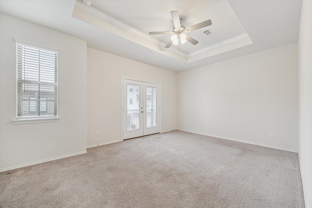 10967 Cannes Memorial Dr, Houston, TX 77043 - empty room featuring a tray ceiling, crown molding, light carpet, french doors, and a ceiling fan
